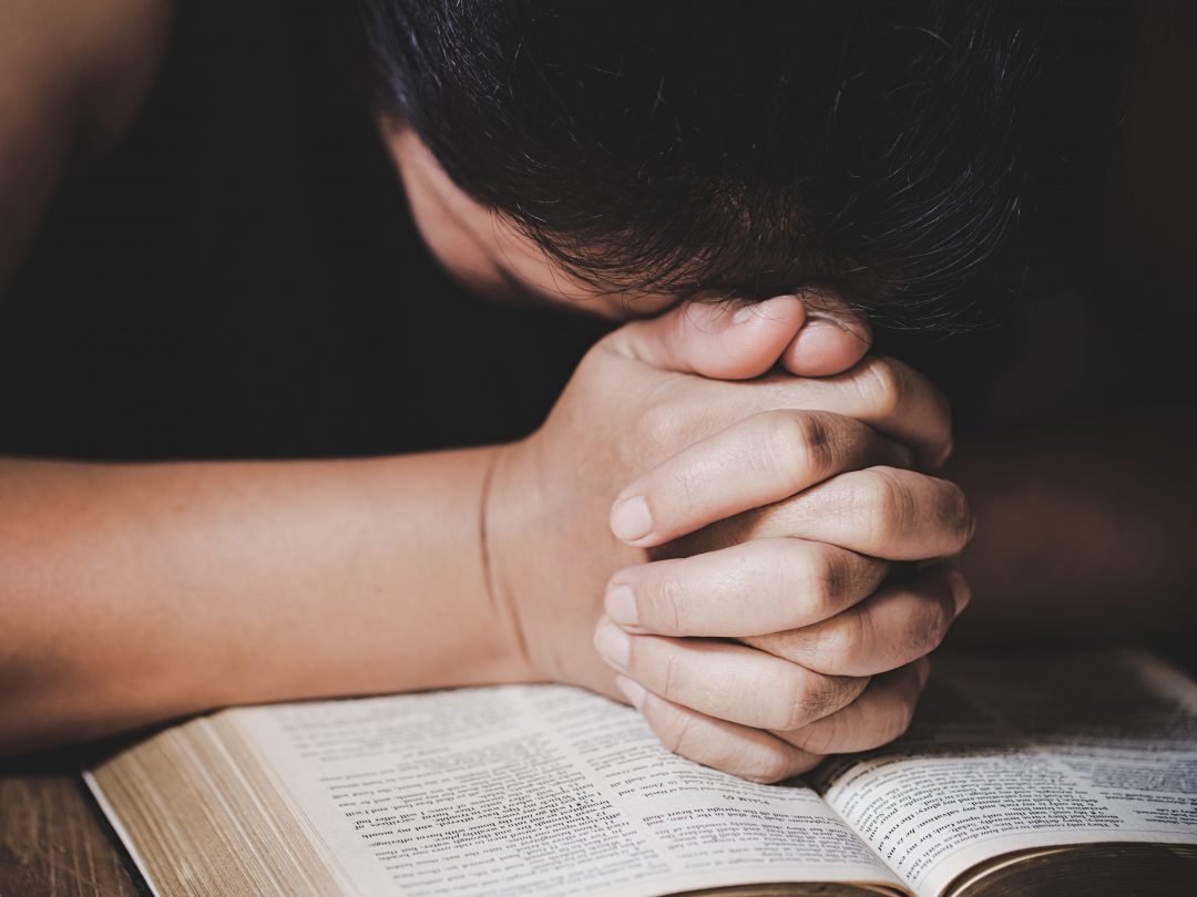 Christian life crisis prayer to god. Woman Pray for god blessing to wishing have a better life. woman hands praying to god with the bible. begging for forgiveness and believe in goodness.